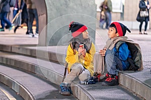 Kids wearing matching winter clothing is sitting on a stair in Chritmas eve in Sendai Japan photo