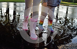 Kids wearing wellingtons in the puddle