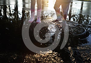 Kids wearing wellingtons in the puddle