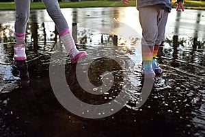 Kids wearing wellingtons in the puddle