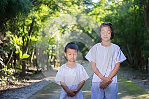 Kids on white clothing , practice walking Meditation in forest t