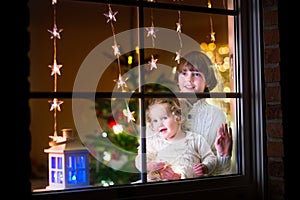 Kids at window on Christmas eve