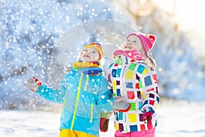 Kids winter snow ball fight. Children play in snow