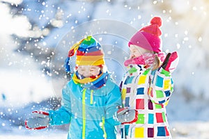 Kids winter snow ball fight. Children play in snow