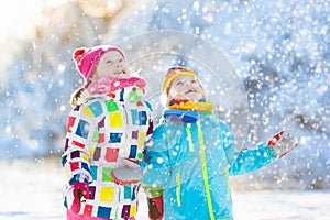 Kids winter snow ball fight. Children play in snow