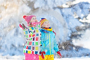 Kids winter snow ball fight. Children play in snow