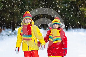 Kids winter snow ball fight. Children play in snow