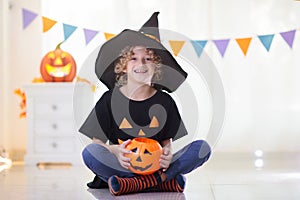 Kids in witch costume on Halloween trick or treat