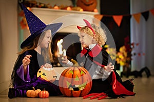 Kids in witch costume on Halloween trick or treat photo