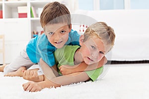 Kids wrestling on the floor - boys game