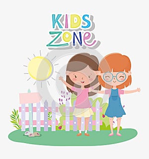 Kids zone, happy little girls with fence sun grass outdoors