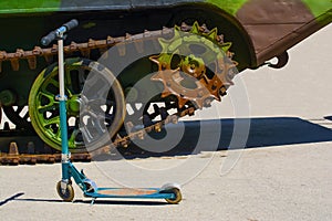 Kidsâ€™ scooter. A caterpillar track of a military vehicle.