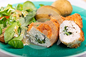 Kiev cutlet with jacket potatoes and salad