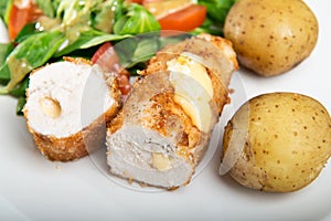 Kiev cutlet with jacket potatoes and salad