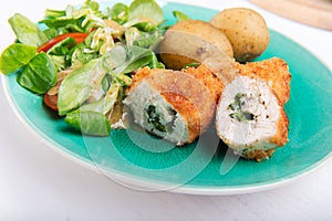 Kiev cutlet with jacket potatoes and salad