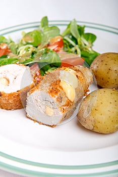 Kiev cutlet with jacket potatoes and salad