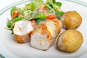 Kiev cutlet with jacket potatoes and salad