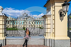 Kiev - A girl sitting on the palace gate