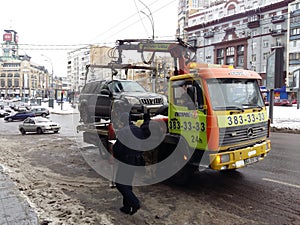 Kiev, March 6, 2018, Ukraine. Traffic police officers on street to pick up intruder`s car on tow truck. Loading tow truck car of