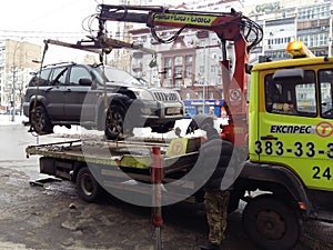 Kiev, March 6, 2018, Ukraine. Traffic police officers on street to pick up intruder`s car on tow truck. Loading tow truck car of