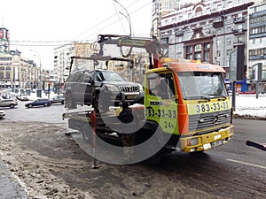 Kiev, March 6, 2018, Ukraine. Traffic police officers on street to pick up intruder`s car on tow truck. Loading tow truck car of