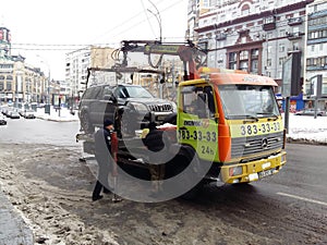 Kiev, March 6, 2018, Ukraine. Traffic police officers on street to pick up intruder`s car on tow truck. Loading tow truck car of