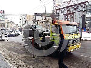 Kiev, March 6, 2018, Ukraine. Traffic police officers on street to pick up intruder`s car on tow truck. Loading tow truck car of