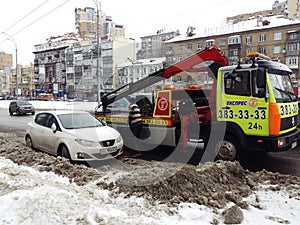 Kiev, March 6, 2018, Ukraine. Traffic police officers on street to pick up intruder`s car on tow truck. Loading tow truck car of