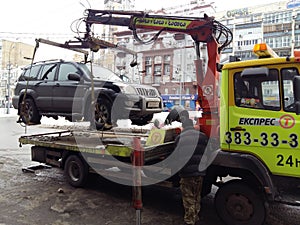 Kiev, March 6, 2018, Ukraine. Traffic police officers on street to pick up intruder`s car on tow truck. Loading tow truck car of