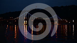 Kiev pedastrian bridge illumination on Dnipro river reflection Ukraine travel