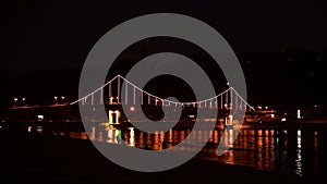 Kiev pedastrian bridge illumination on Dnipro river reflection Ukraine travel