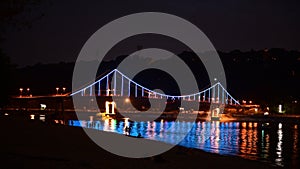 Kiev pedastrian bridge illumination on Dnipro river reflection Ukraine travel