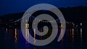 Kiev pedastrian bridge illumination on Dnipro river reflection Ukraine travel