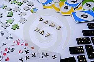 Kiev, Ukraine - 10.03.2021 Text GAME DAY. Dominoes puzzles playing cards around. The concept of relaxation from
