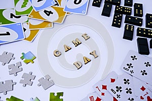 Kiev, Ukraine - 10.03.2021 Text GAME DAY. Dominoes puzzles playing cards around. The concept of relaxation from information and