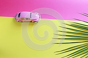 KIEV, UKRAINE - August 23, 2019: Palm leaf and toy car background with copy space. Background for writing text about