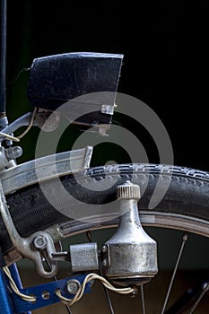 KIEV, UKRAINE - AUGUST 23, 2020: Close up of vintage headlights of a bicycle. Retro bike dynamo machine