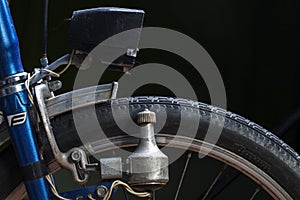 KIEV, UKRAINE - AUGUST 23, 2020: Close up of vintage headlights of a bicycle. Retro bike dynamo machine