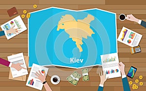 Kiev ukraine capital city region economy growth with team discuss on fold maps view from top