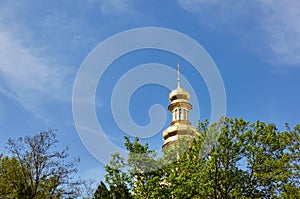 Church building architecture, Pechersk Lavra monastery with golden cupol against blue sky background
