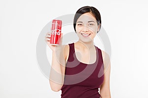 KIEV, UKRAINE - 06.28.2018: Happy asian, korean woman hold Coca Cola jar. Sweet water. Illustrative editorial. Copy space