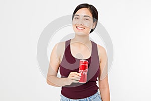 KIEV, UKRAINE - 06.28.2018: Happy asian, korean woman hold Coca Cola jar. Sweet water. Illustrative editorial. Copy space