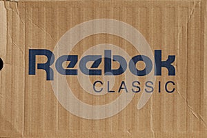 KIEV, UKRAINE-JULY 19,2017: blue Reebok sign with light brown background, Reebok International Ltd. - Sports shoe and sewing compa