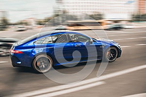 Kiev, Ukraine - June 19, 2021: Blue Mercedes-Benz GT 63 S AMG V8 BiTurbo in motion. Blurred car. Mercedes AMG at high speed