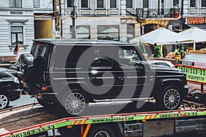 Kiev, Ukraine - June 19, 2021: New Mercedes G-class V8 being driven on a tow truck. New car