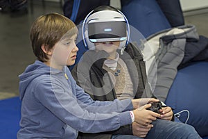 Kiev, Ukraine - 08 October 2017: Children get acquainted with the points of virtual finality at the exhibition of consumer electro