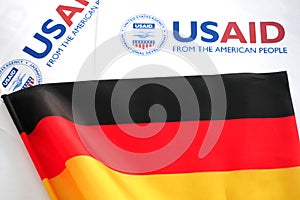 Kiev, Ukraine - 02 12 2023: USAid logo and Germany flag, USAid is USA agency for international development - assistance abroad,