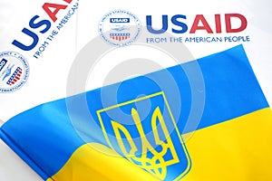 Kiev, Ukraine - 02 12 2023: USAid logo and ukrainian flag, USAid is USA agency for international development - assistance abroad