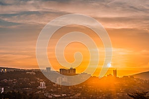 Kigali city centre skyline and surrounding areas under a golden sky at sunset photo