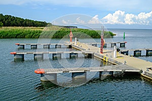 Kihnu, Estonia - June 23, 2023: The territory of a small port on the island of Kihnu. Docks for small ships photo
